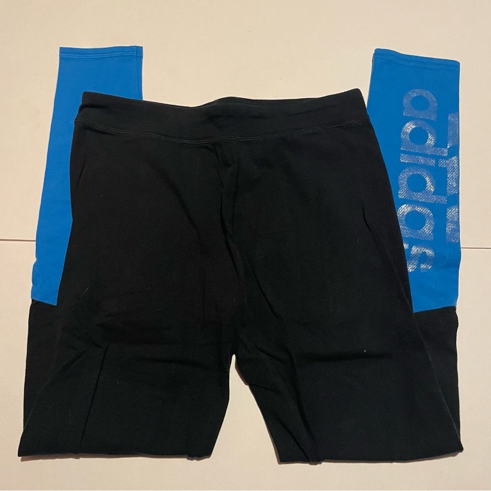 Adidas black athletic leggings with blue color blocks on the legs